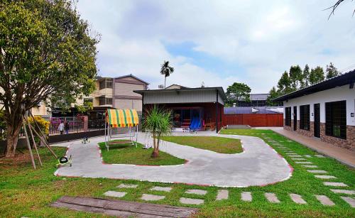 a playground with a giant chair in a yard at Taomi 5211 B&B in Puli