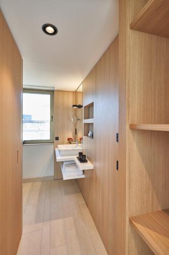 a bathroom with a sink and a mirror at Hotel Misan in Norderney