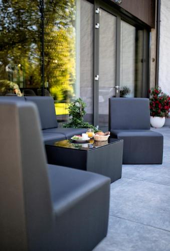 two chairs and a coffee table on a patio at Hotel Das Essigmanngut in Anif