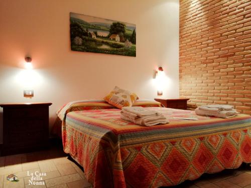 a bedroom with a bed with towels on it at La Casa della Nonna in Brisighella