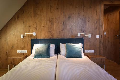 sypialnia z dużym łóżkiem i drewnianymi ścianami w obiekcie Villa Bałtycka w Gdańsku