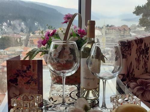 a bottle of wine and two wine glasses on a table at Safi in Dospat