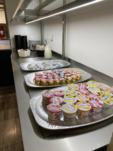 a counter with several trays of cupcakes and muffins at K BUSINESS in Zuchwil