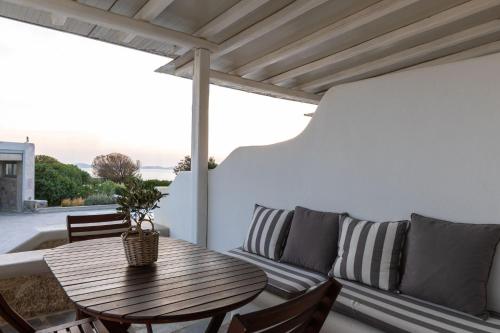 a living room with a wooden table and a couch at Sea Wind Villas and Suites in Tourlos