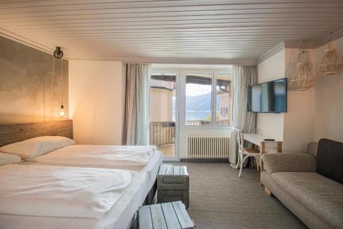 ein Hotelzimmer mit einem Bett und einem Sofa in der Unterkunft Seven Boutique Hotel in Ascona