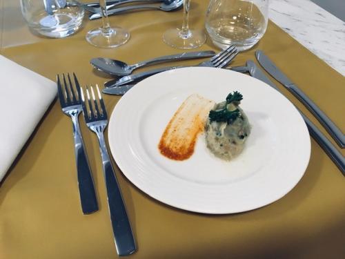 a white plate with a piece of food on a table at Résidence Services DOMITYS La Cantate in Dunkerque