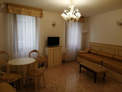 a living room with a couch and a table at Hotel Orion in Venice