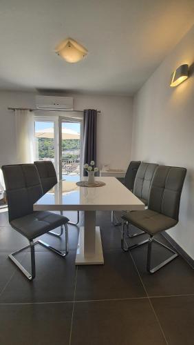 a dining room with a table and two chairs at Apartments with sea view in Stomorska