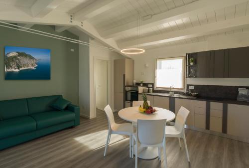 a living room with a blue couch and a table and chairs at Le Terre di Maluk in Monte San Vito
