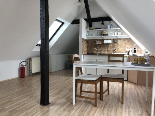 a kitchen with a table and chairs in a loft at Einzel-Apartment Düsseldorf Oberkassel in Düsseldorf