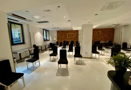 a conference room with black chairs and tables at Timeout Heritage Hotel Zagreb in Zagreb