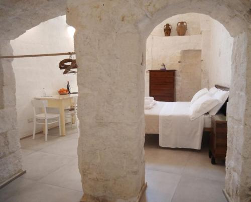 a bedroom with a bed and a table in a room at Palazzo Enselmi in Matera