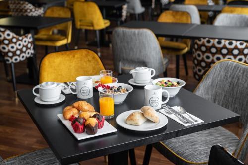 a black table with breakfast food on it at Eurostars Atlántico in A Coruña