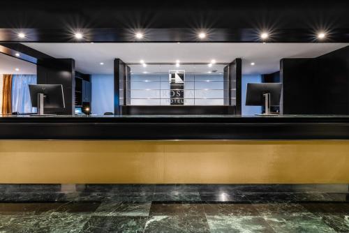 a barbershop with a yellow and black counter at Eurostars Atlántico in A Coruña