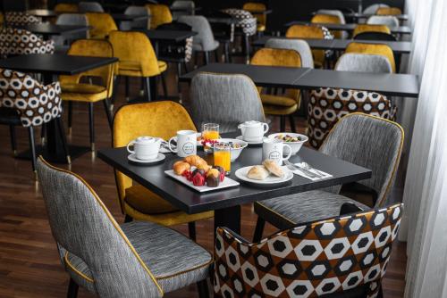 a table with breakfast food on it in a restaurant at Eurostars Atlántico in A Coruña
