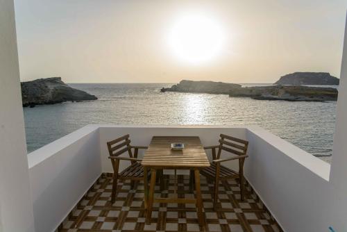 a table and chairs on the back of a boat at THE SHIP in Lefkos Karpathou