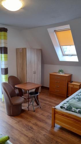 a bedroom with a desk and a table and a bed at Agroturystyka Pokoje u Zosi in Odrowąż