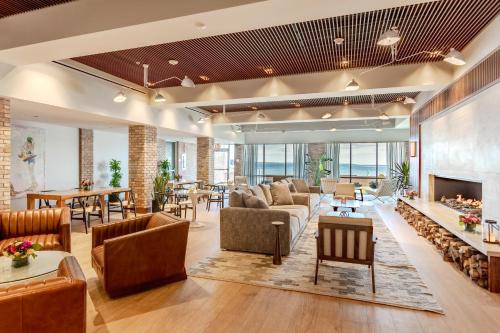 a living room with furniture and a fireplace at Delamar Traverse City in Traverse City