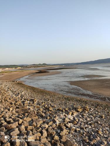 a large group of rocks on a beach at THE TREVONE, Llandudno in Llandudno