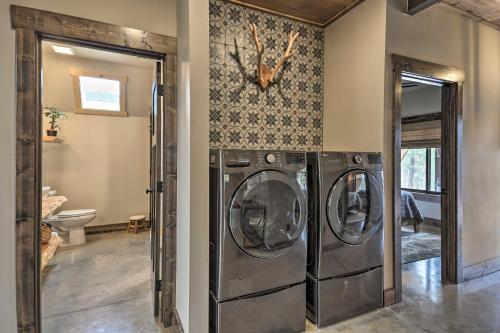 a laundry room with three washing machines in it at Modern Lead A-Frame with Hot Tub Hike, Bike and ATV! in Lead