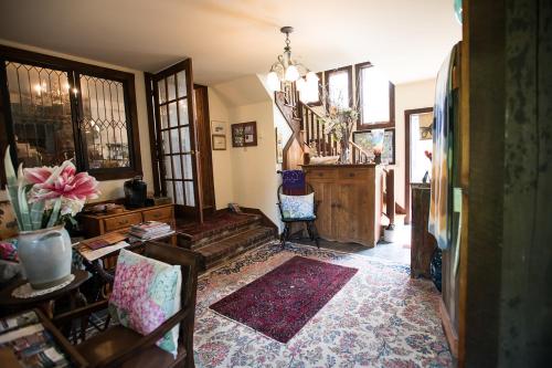 a living room with a staircase and a room with chairs at Gardenview Bed and Breakfast in Newport