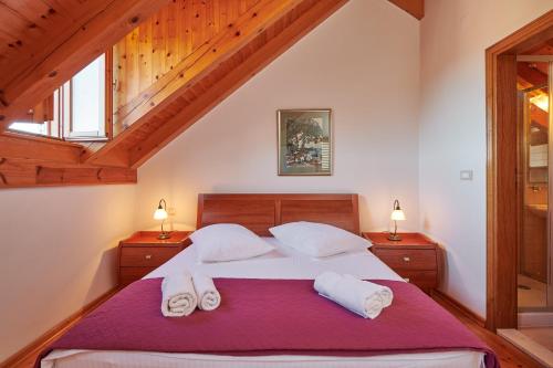 a bedroom with a bed with two towels on it at Villa Sole in Cavtat