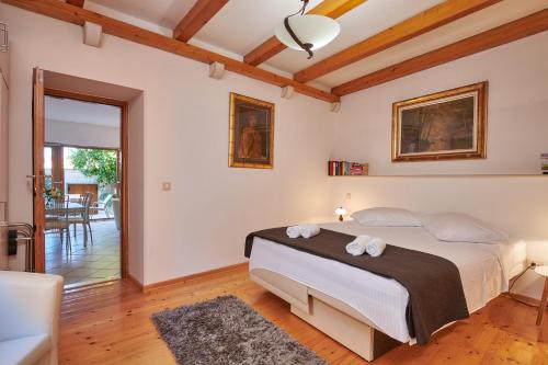 a bedroom with a large bed with towels on it at Villa Sole in Cavtat