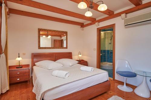 a bedroom with a bed with two towels on it at Villa Sole in Cavtat
