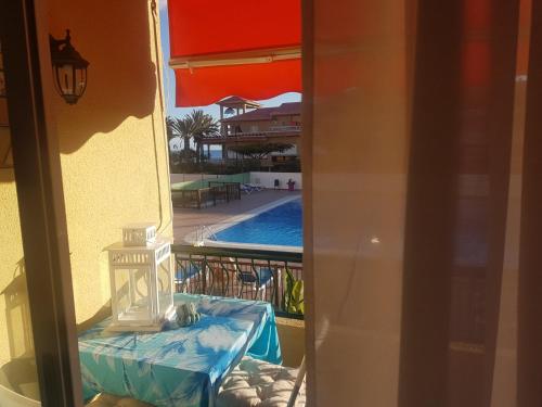 a view of a swimming pool from a balcony at PLAYA LAS VISTAS LOFT in Los Cristianos