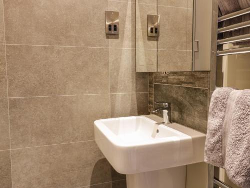 a bathroom with a sink and a mirror at The Old Byre in Jedburgh