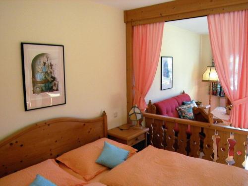 a bedroom with a bed and a couch at Appartements Pension Elfi in Gosau