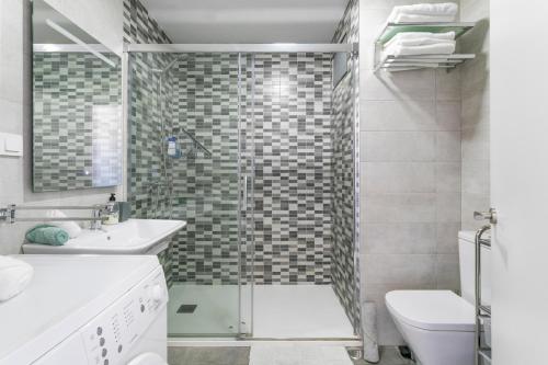 a bathroom with a shower and a sink and a toilet at Beach Suite, city & mountain view in Alicante