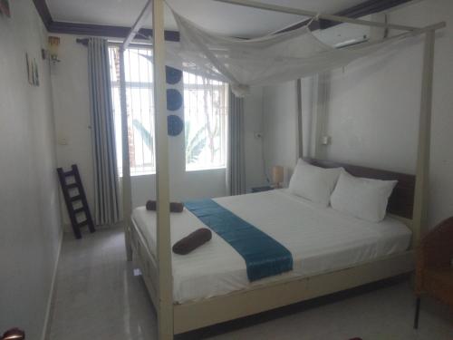 a bedroom with a bed with a canopy bed at Manoha Villa in Sihanoukville