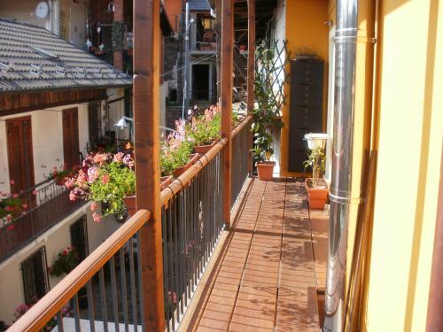 a balcony with potted plants and flowers on it at B&B Il Castello Lago Maggiore con TERRAZZA in Cossogno