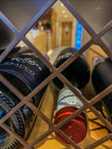 a bunch of bottles of wine in a cage at Locanda La Baita in Santo Stefano di Cadore
