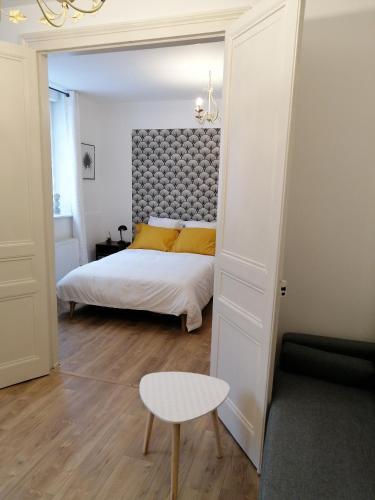 una camera da letto con un letto, un tavolo e una sedia di Au pied des remparts ... a Boulogne-sur-Mer