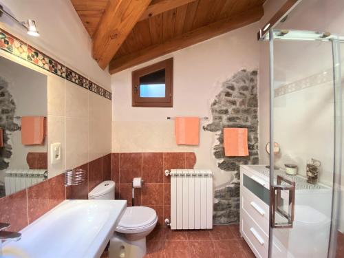 a bathroom with a tub and a toilet and a sink at VILLA SALVIA - Holiday house with pool - in Jurdani