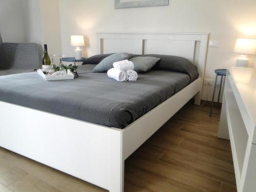 a large white bed with two stuffed animals on it at Cave Garden rooms in Favignana