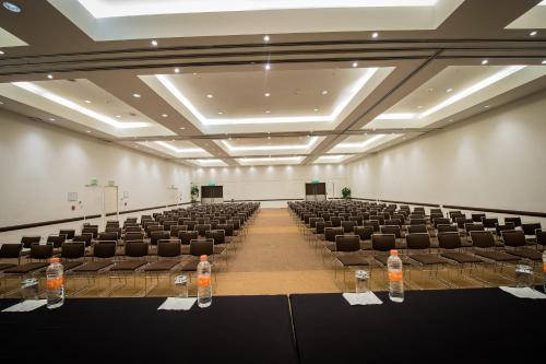 an empty room with chairs and bottles of water in it at Holiday Inn Mexico City-Plaza Universidad by IHG in Mexico City