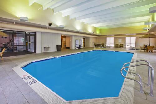 a large swimming pool in a large room with a hotel at DoubleTree by Hilton Rapid City Downtown Convention Center in Rapid City