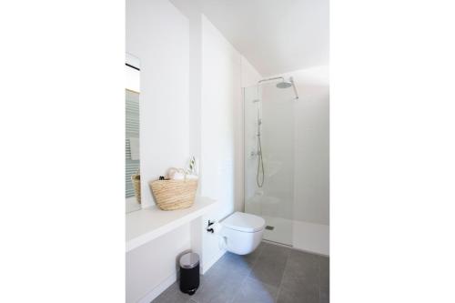 a bathroom with a toilet and a shower at Hotel Rural Mas de l'Illa in Tivissa