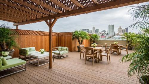 a patio with tables and chairs on a deck at Holiday Inn San Francisco - Golden Gateway newly renovated with No Resort Fee in San Francisco