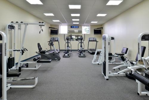 a gym with several treadmills and exercise bikes at Ramada Plaza by Wyndham Sheridan Hotel & Convention Center in Sheridan