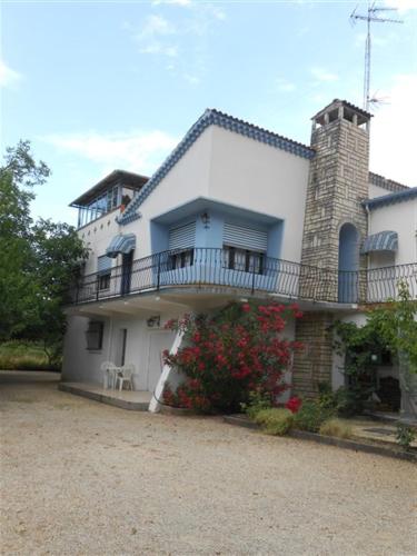 a large white house with a balcony on top of it at Villa NORICA in Bordezac