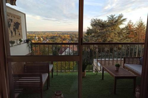 a balcony with a view of the fall foliage at Un petit paradis pour se détendre et se ressourcer in Montrichard