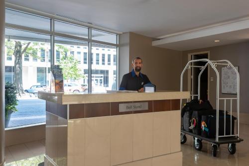 a man standing at a counter in an airport at Holiday Inn Washington Capitol-National Mall by IHG in Washington