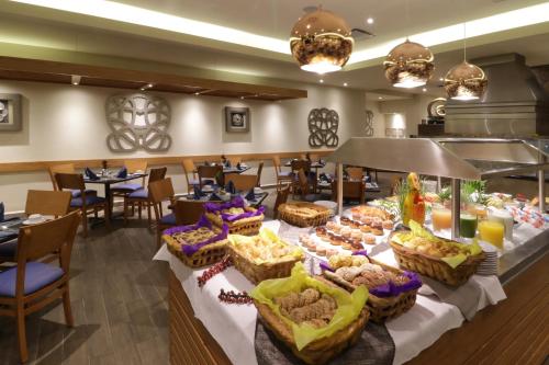a buffet in a restaurant with tables and chairs at Holiday Inn Monterrey Norte by IHG in Monterrey