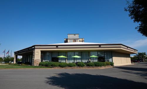 a building with green umbrellas in front of it at Holiday Inn St. Louis Airport West Earth City by IHG in Earth City