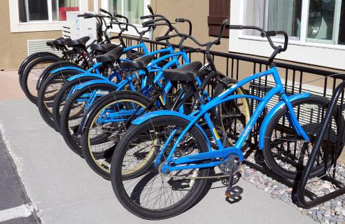 a row of blue bikes parked next to a fence at Holiday Inn West Yellowstone by IHG in West Yellowstone