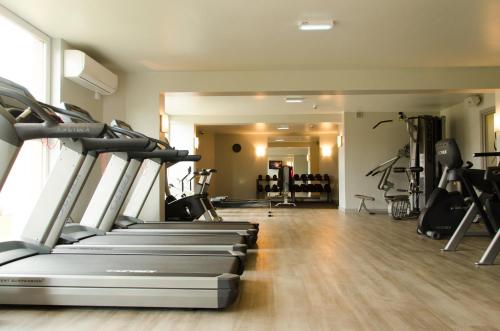 a gym with treadmills and elliptical machines at Holiday Inn Newcastle Gosforth Park by IHG in Newcastle upon Tyne